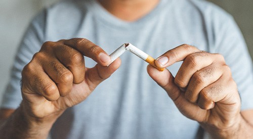 Closeup of patient breaking cigarette