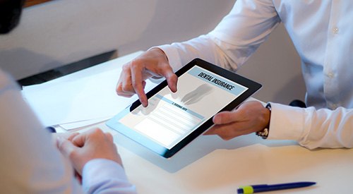 Patient reviewing dental insurance form on tablet