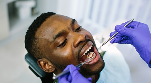 Dentist looking at patient's teeth