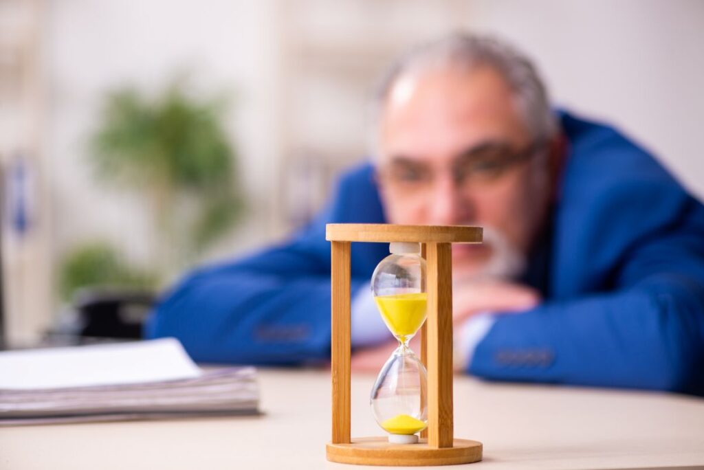 A man watching a sand timer